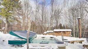 A hot tub partially covered in snow, surrounded by a wooden deck and a stack of firewood. - 4 Mi to Sugarbush Resort: Waitsfield Retreat (Waitsfield)