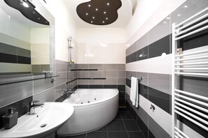 A modern bathroom with two sinks, a bathtub, and a towel rack. - L U X E Split Luxury Rooms (Split)