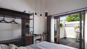 Un dormitorio moderno con una cama grande, un escritorio y un pequeño balcón con hidromasaje.