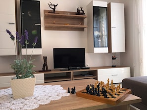 Family Apartment, Multiple Beds, Courtyard View | Living area | Flat-screen TV