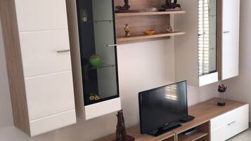 Family Apartment, Multiple Beds, Courtyard View | Living area | Flat-screen TV