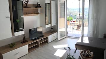 Family Apartment, Multiple Beds, Courtyard View | Living area | Flat-screen TV