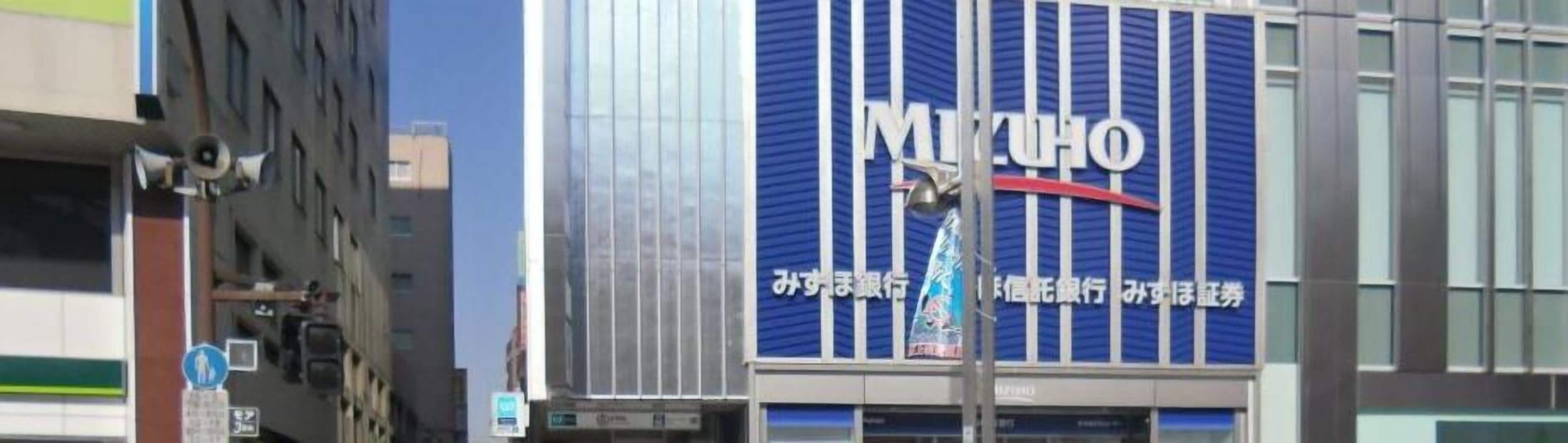 A building with a prominent blue and white sign reading "Mitsubishi" and additional Japanese text.