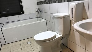 A bathroom with a toilet, a bathtub, and a sink. - My House (Luodong)