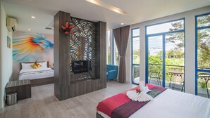 A modern hotel room with a large bed, a TV, a balcony with chairs, and a decorative wall. - Blue Boutique Villa Hoi An (Da Nang)