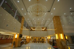 A spacious lobby with a grand chandelier, marble flooring, and a reception desk. - Grand Park Hotel (Mandalay)