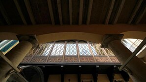 An arched ceiling with intricate patterns and a view of a balcony with columns. - Villa della Torre in Città (Verona)