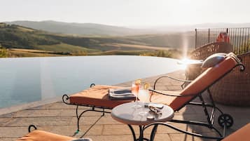 Seasonal outdoor pool, open 8:00 AM to 8:00 PM, pool umbrellas