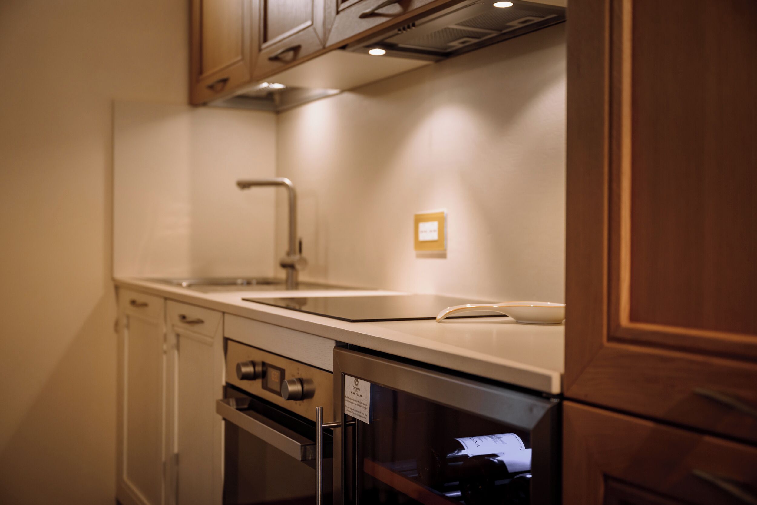 A kitchen with a stainless steel oven, a built-in microwave, and a sink.