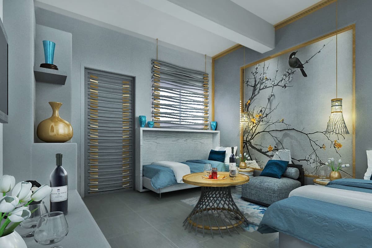 A modern bedroom with a large bed, a smaller sofa, a round coffee table, and a wall-mounted lamp.