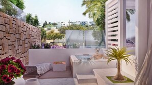 A modern spa area with a stone wall, a glass-enclosed hot tub, and a view of the city. - Kellys Plus (Rhodes)