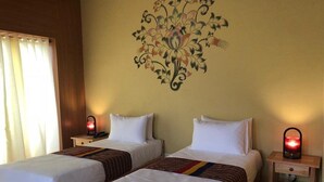 A hotel room with two beds, a wall mural, and bedside lamps. - Spirit of Bhutan Resort (Paro)