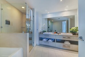 Bathtub, hair dryer, towels, shampoo