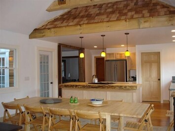 Dining room, looking into kitchen with the original 1940 roof detail over bar
