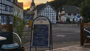 A signboard with the name 'GEROLSTEINER' and a list of amenities including a restaurant, a pub, and a coffee shop.