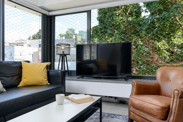 Premium Condo, Multiple Beds, City View | Living area | Flat-screen TV