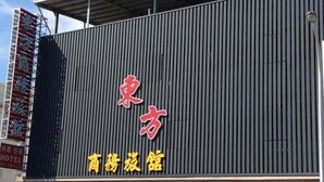 Un edificio con un letrero que dice "東方商旅館" (Dongfang Shantang).