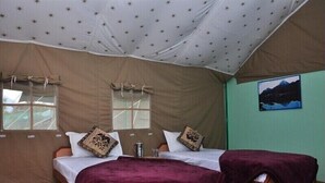 A tented room with two beds, star-patterned ceiling, and a painting on the wall. - Natures Outpost Camps (Kullu)