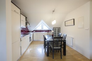 Enjoy meals in the spacious kitchen and dining area with an oven and a dining table.
