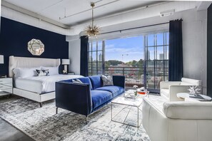 Living and sleeping area at this Ponce Rental with couches and bed - Ponce City Market Studio · Market Views · Walk to BeltLine (Atlanta)