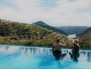 A swimming pool with a view of a valley and a mountain.