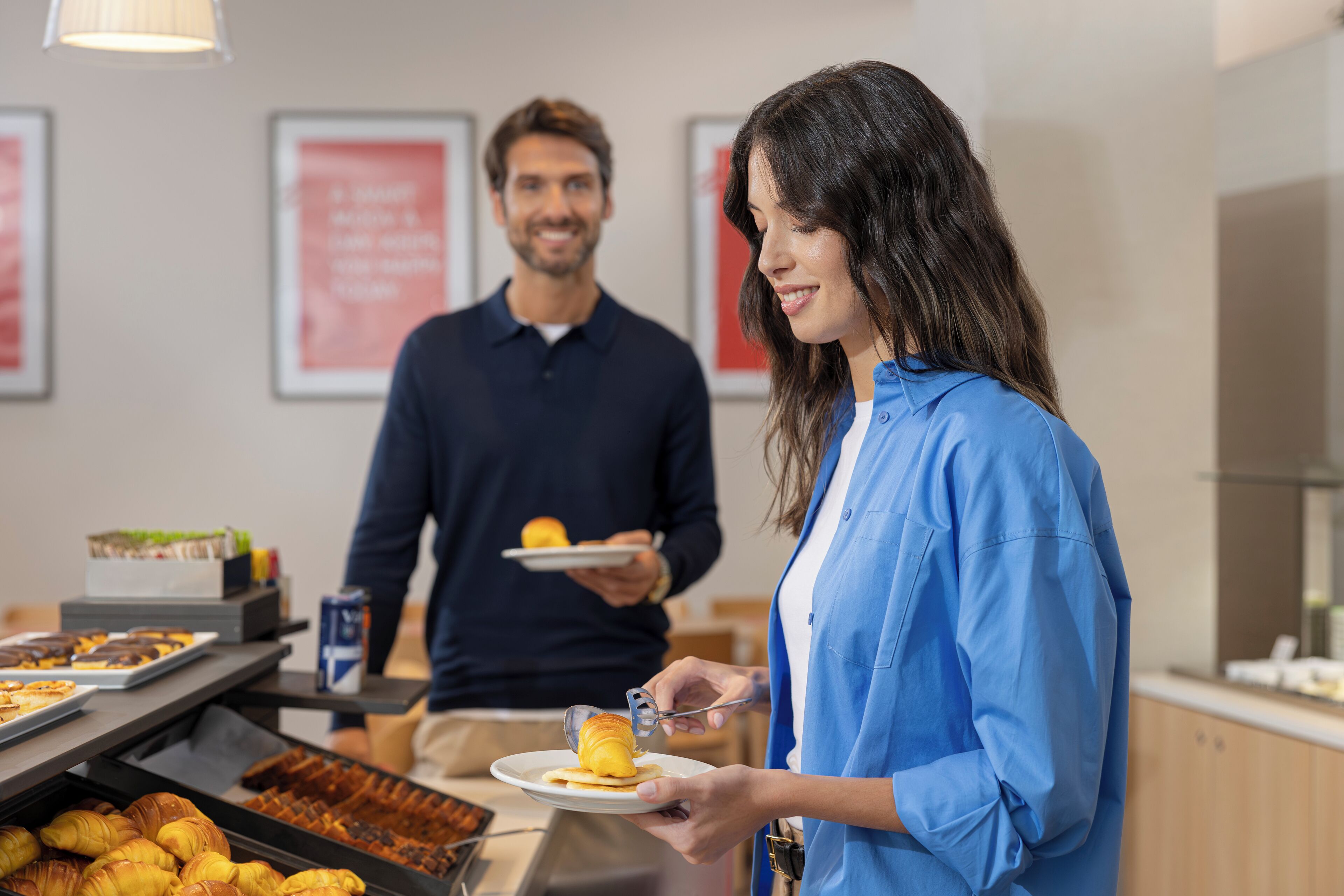 A breakfast buffet with pastries and a coffee machine.
