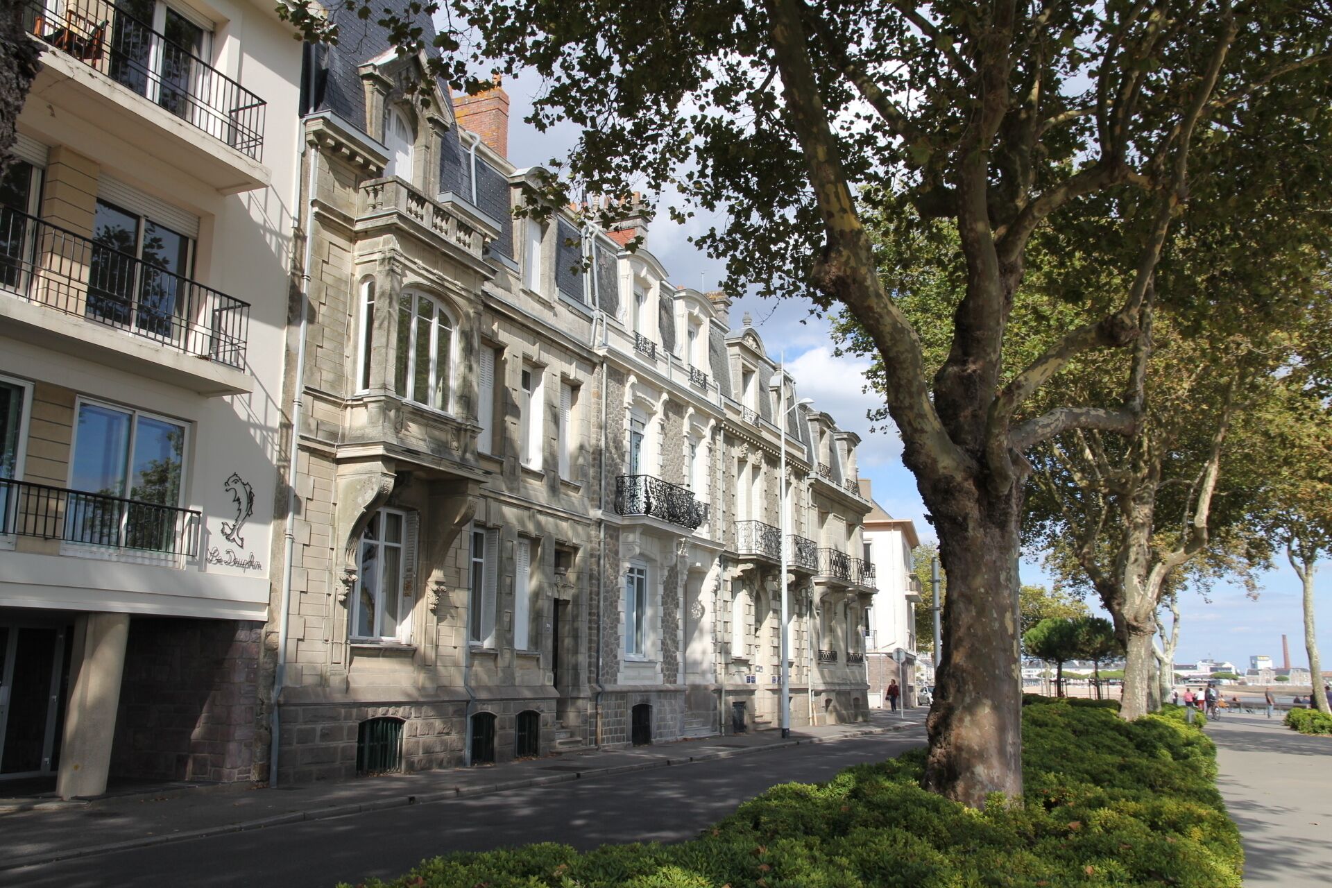 A historic building with classical architecture, featuring multiple balconies and large windows.