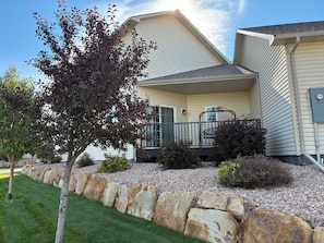 A residential house with a sloped roof, a front porch, and a stone retaining wall. - Comfy Gathering Place for Friends or Family! (Montrose)
