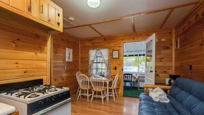 A cabin interior with a kitchen, dining area, and living room.