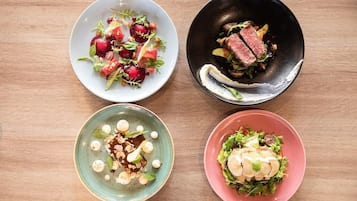 Four dishes on a wooden table.