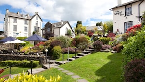 A garden with a stone staircase leading to a building labeled "The Angel Inn."