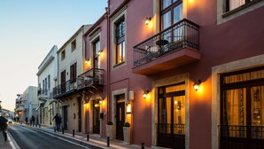 A row of buildings with balconies, large windows, and outdoor lighting. - Phaedra Suites (Rethymno)