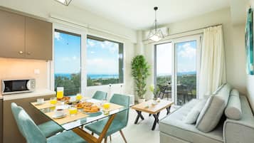 Apartment, 1 Bedroom, Sea View | Living room | Flat-screen TV