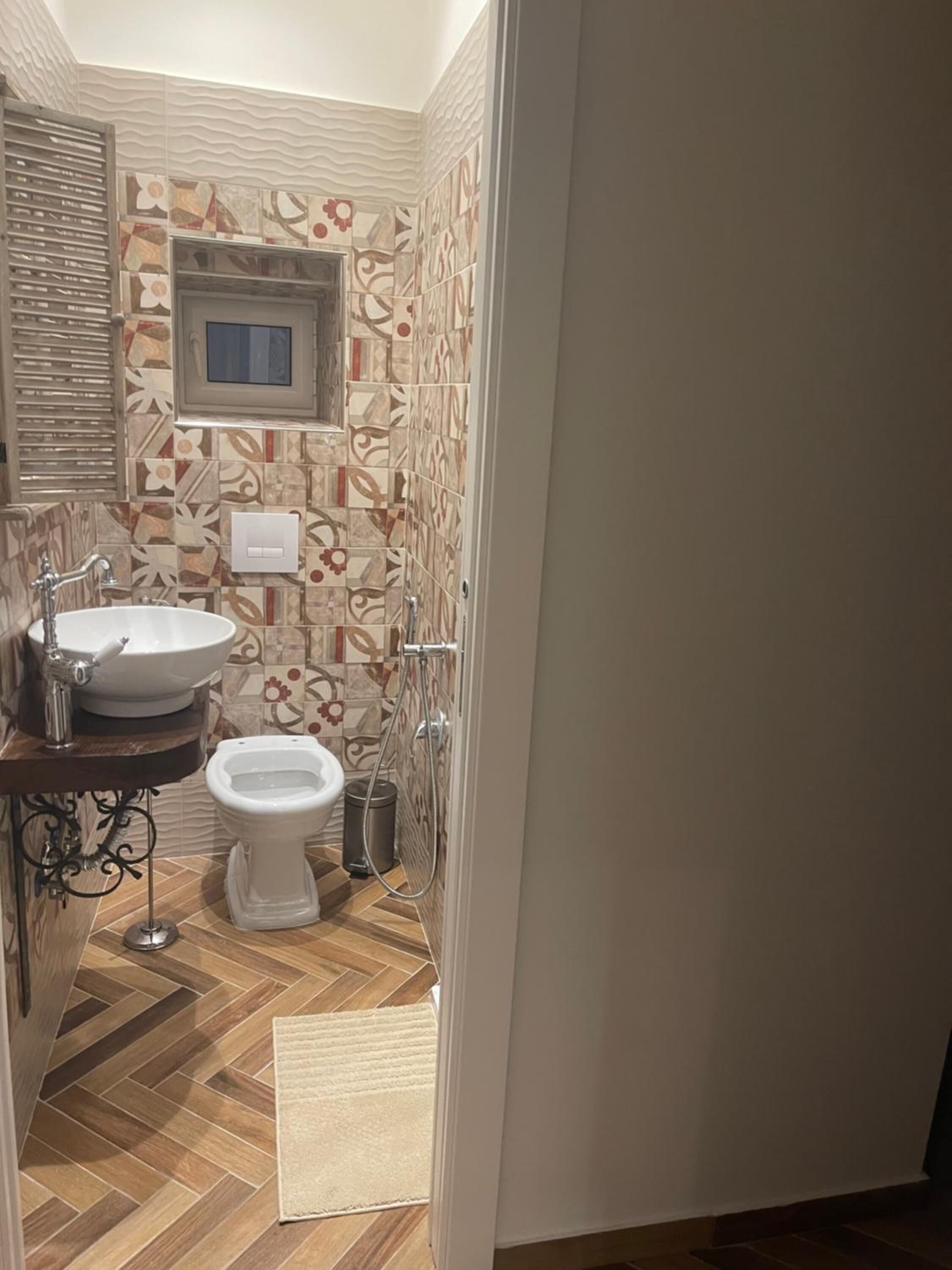 A bathroom with a sink, toilet, and shower.