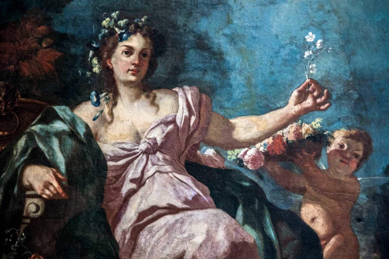 Un tableau classique représentant une figure assise, un enfant et un adulte dont on ne voit qu’une partie.