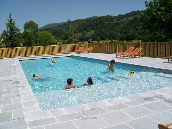 Seasonal outdoor pool, pool umbrellas, pool loungers