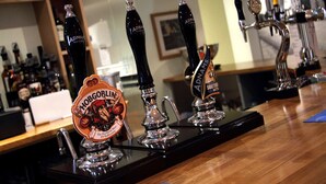 A bar with multiple taps, including a prominently displayed 'Hogwarts' tap. - Little Downham Anchor (Ely)