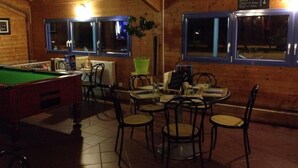 A billiards table, a pool table, and a dining area with chairs and a table. - Ridorev (Auxonne)