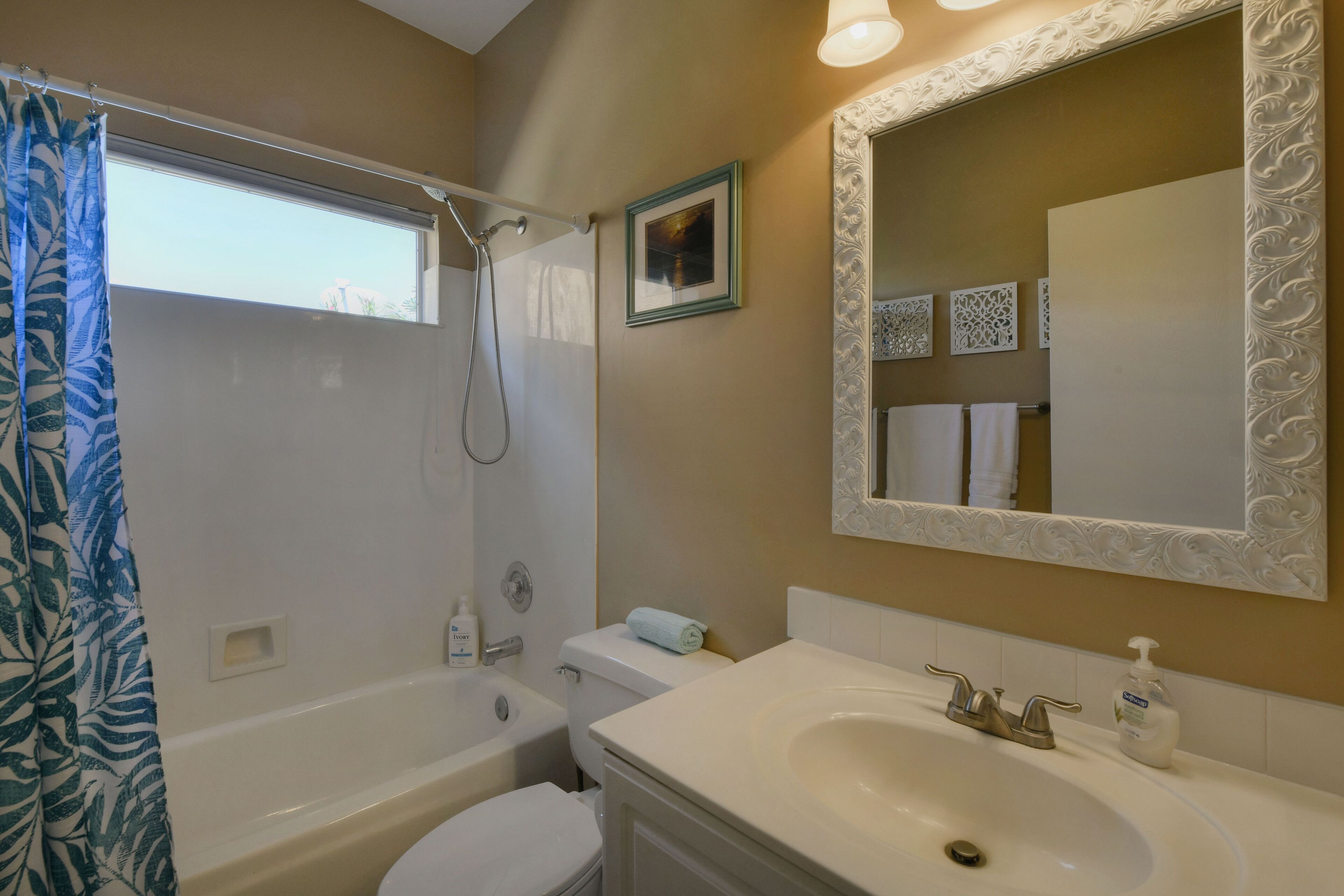 A bathroom with a bathtub, toilet, and sink.