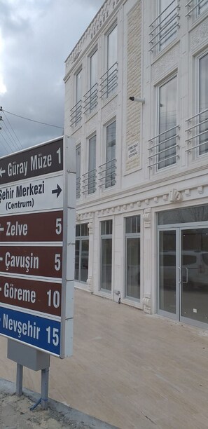 A directional sign with multiple destinations and distances.