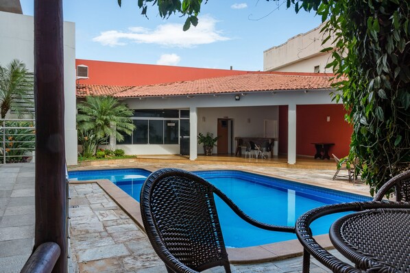 Outdoor pool, open 6:00 AM to 10:00 PM, pool loungers