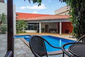 Outdoor pool, open 6:00 AM to 10:00 PM, pool loungers