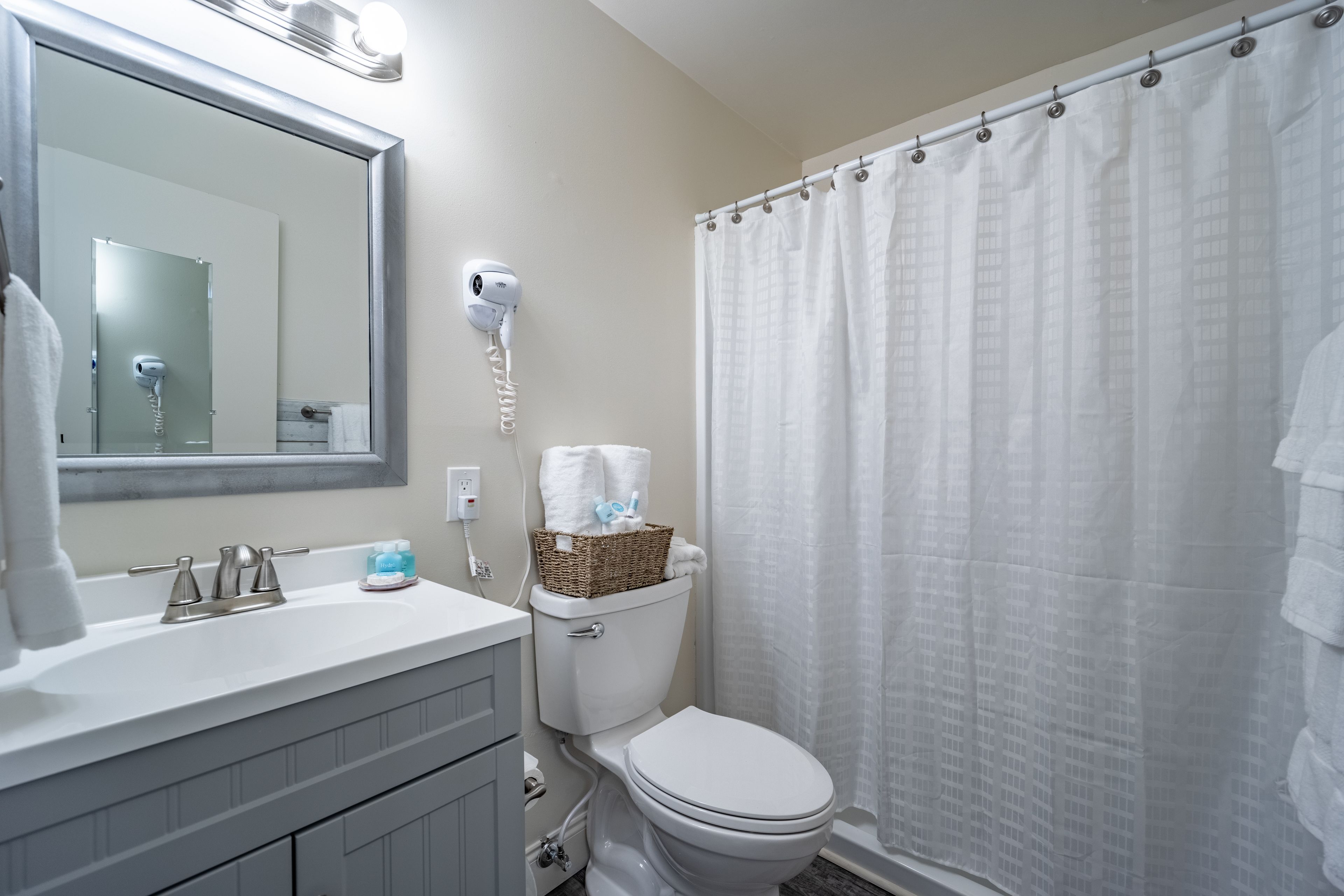 combined shower/bathtub, designer toiletries, hair dryer, towels