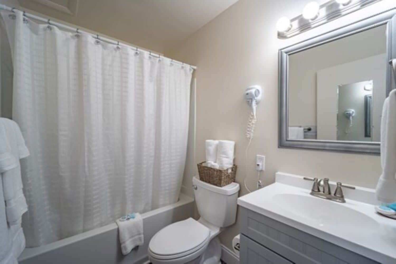 combined shower/bathtub, designer toiletries, hair dryer, towels