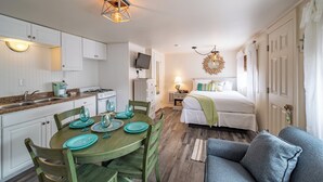 A compact living space with a kitchen, dining area, and a bedroom. - Ocean Glass Inn (Rehoboth Beach)