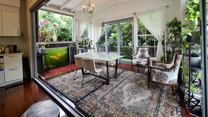 Un coin repas avec une table en verre, des chaises et un tapis à motifs.