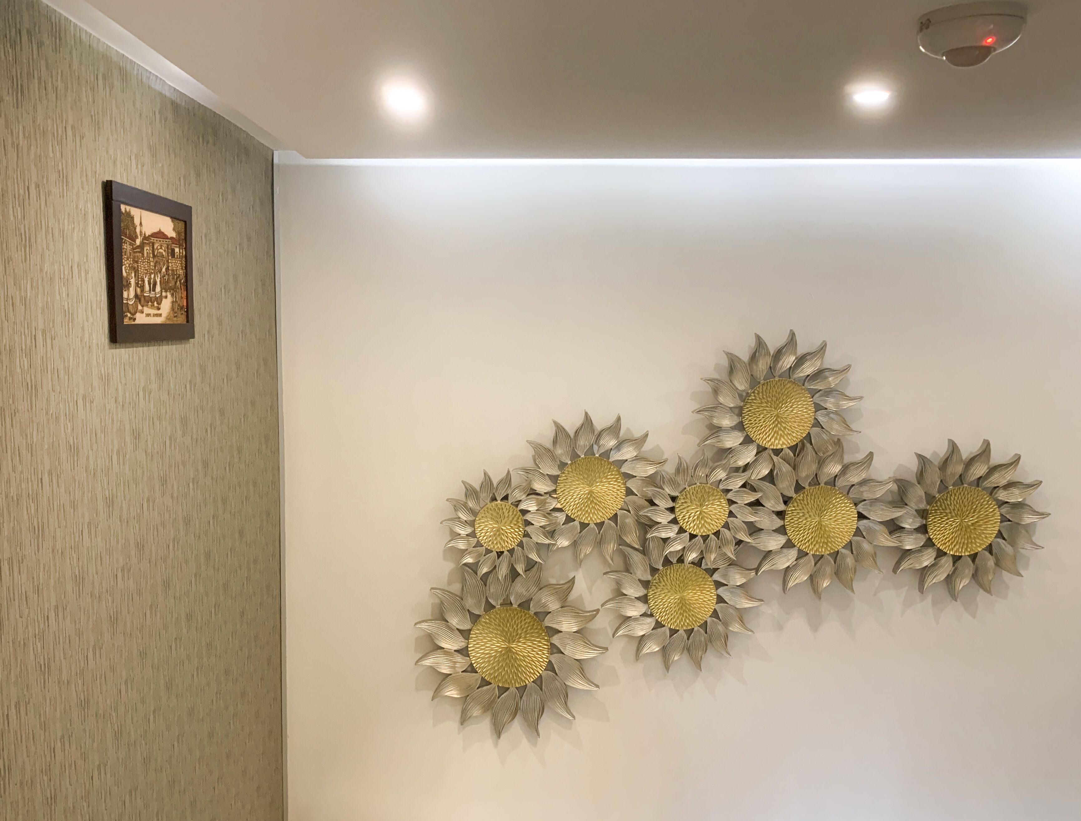 A wall with a textured pattern and a framed picture.