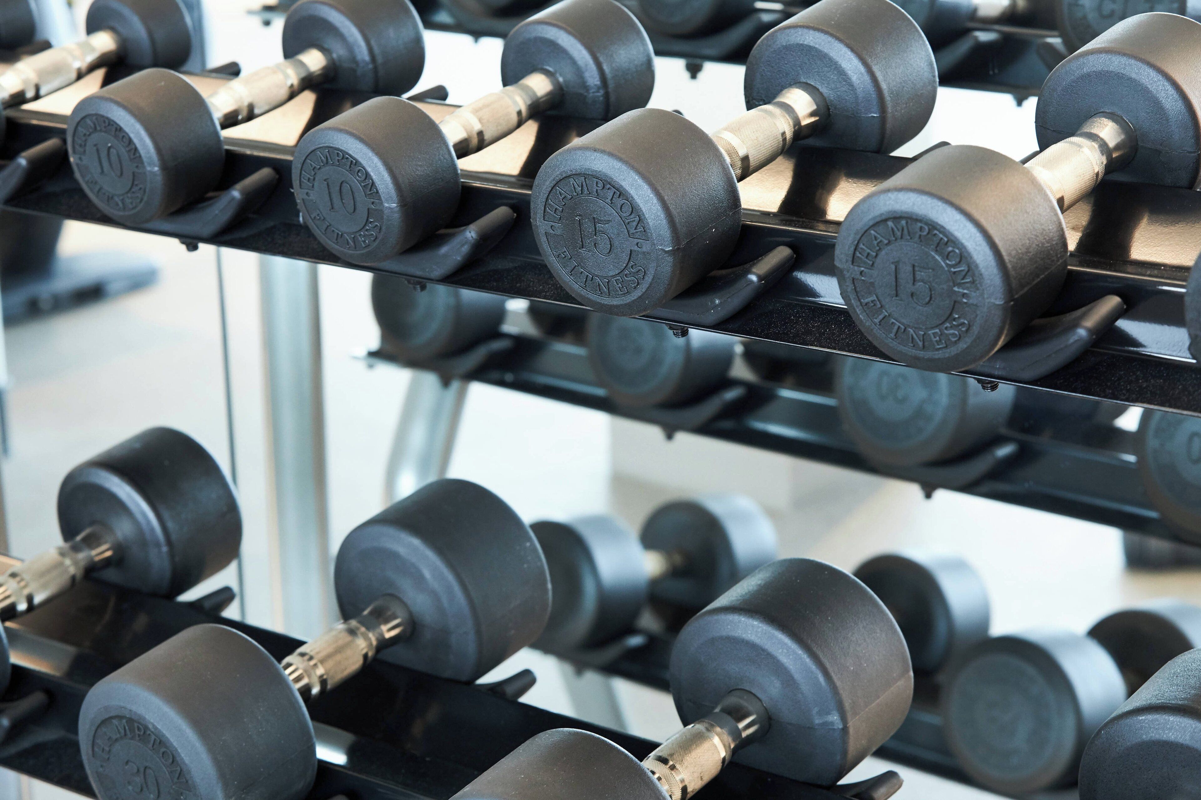 A rack of dumbbells with weights marked 10, 15, and 30 lbs.