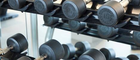 A rack of dumbbells with weights marked 10, 15, and 30 lbs.