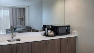 A modern kitchen with a built-in microwave, a sink, and a countertop.